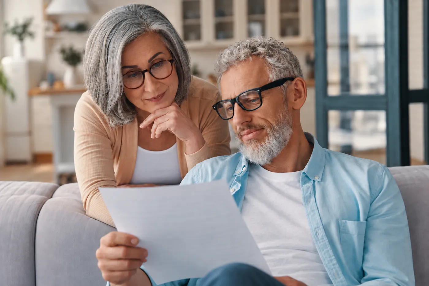 Two adults reading through trust paperwork together at home